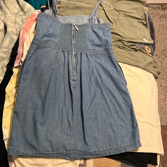 This is a mini Jean dress with pockets and zip up in the back - Picture 2 of 2